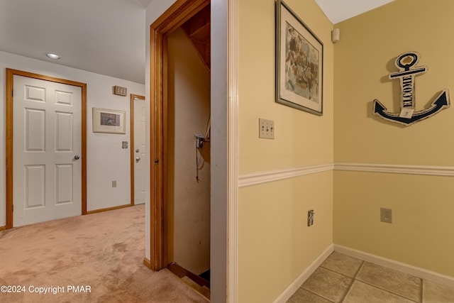 hallway featuring recessed lighting, light colored carpet, baseboards, and light tile patterned flooring