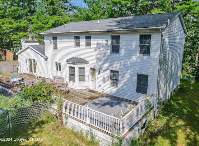 view of front of house with a shingled roof, fence, and a wooden deck