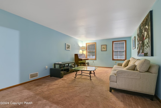 carpeted living area with visible vents and baseboards