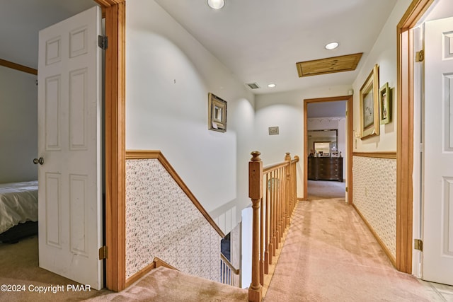 corridor featuring visible vents, light colored carpet, a wainscoted wall, an upstairs landing, and recessed lighting