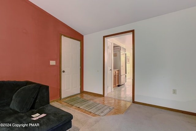 living area with lofted ceiling and baseboards