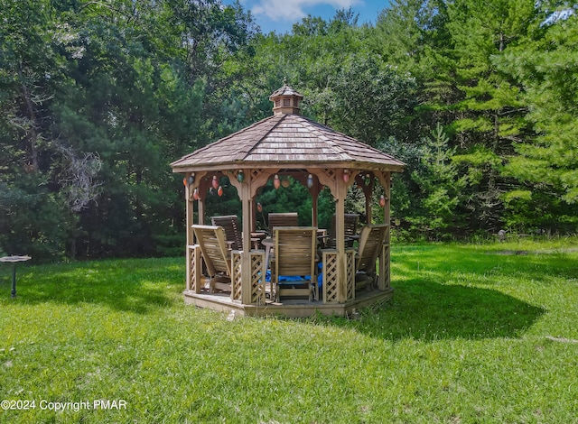 exterior space with a forest view and a gazebo