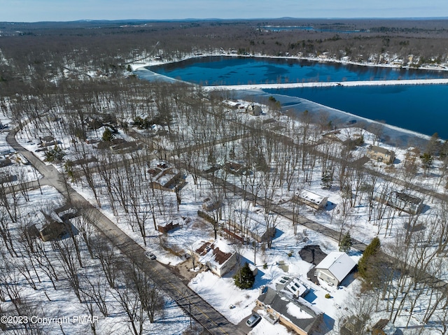 snowy aerial view featuring a water view