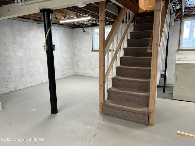 basement featuring washer / dryer and stairs