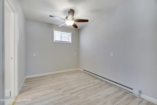 unfurnished room featuring a baseboard heating unit, ceiling fan, baseboards, and wood finished floors