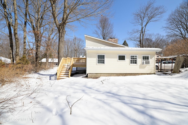 exterior space featuring stairway, a chimney, and a wooden deck