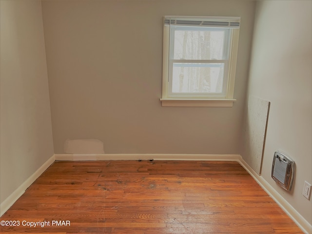 empty room featuring baseboards and wood finished floors