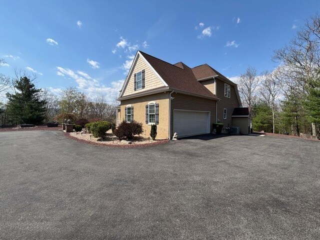 389 Joanne Ct, Bartonsville, PA 18321 - view of side of home featuring driveway and stucco siding