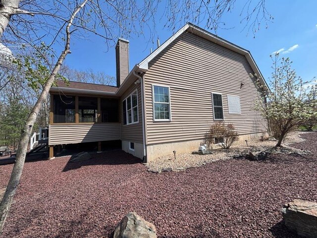 389 Joanne Ct, Bartonsville, PA 18321 - view of home's exterior with a chimney and a sunroom