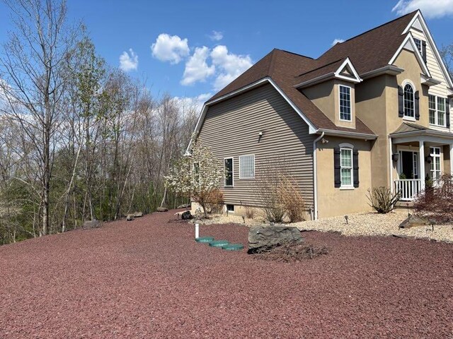 389 Joanne Ct, Bartonsville, PA 18321 - view of home's exterior featuring stucco siding and a shingled roof