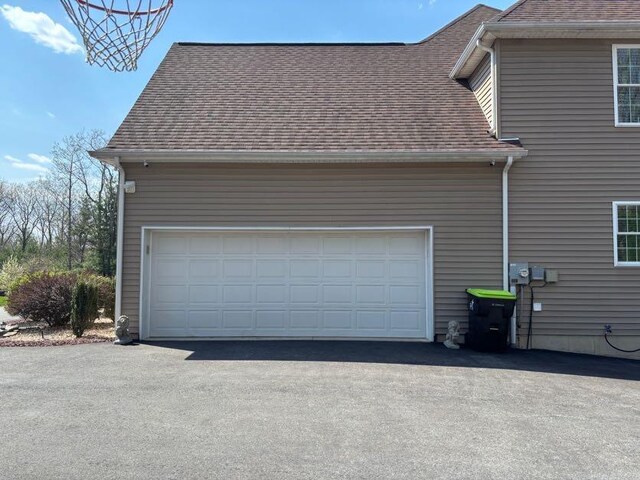 389 Joanne Ct, Bartonsville, PA 18321 - view of property exterior with a shingled roof and asphalt driveway