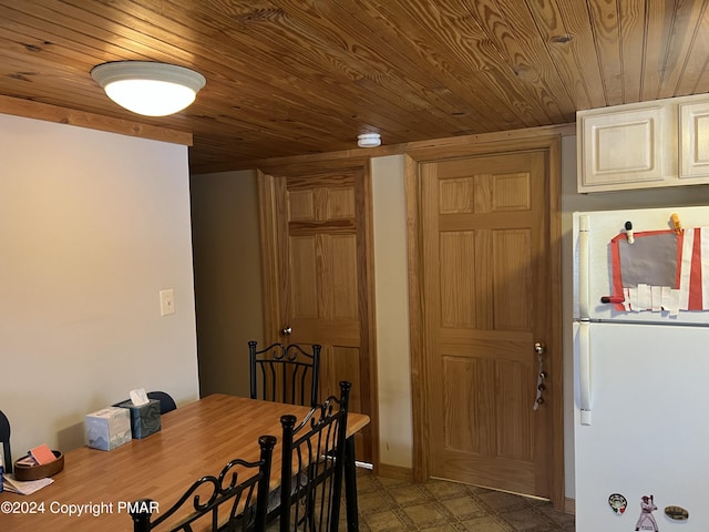 dining area featuring wooden ceiling and tile patterned floors