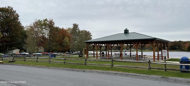 view of community featuring fence and a gazebo