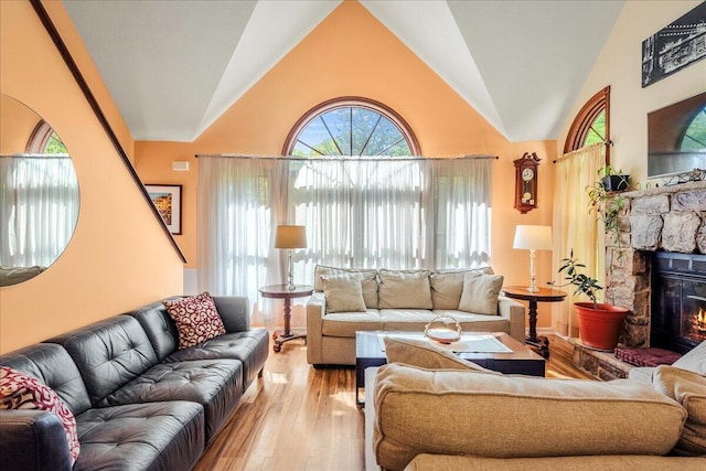 349 Mallard Ln, Bushkill, PA 18324 - living room with a stone fireplace, wood finished floors, and high vaulted ceiling