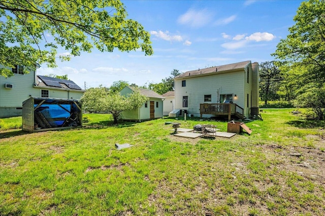 349 Mallard Ln, Bushkill, PA 18324 - rear view of property featuring a wooden deck, a yard, and an outdoor fire pit