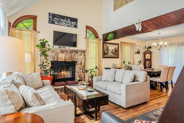 349 Mallard Ln, Bushkill, PA 18324 - living room featuring a chandelier, wood finished floors, high vaulted ceiling, and a fireplace