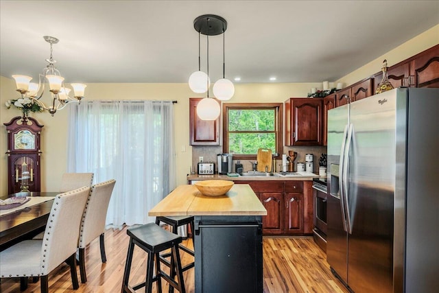 349 Mallard Ln, Bushkill, PA 18324 - kitchen with appliances with stainless steel finishes, a chandelier, a center island, a breakfast bar, and light wood finished floors