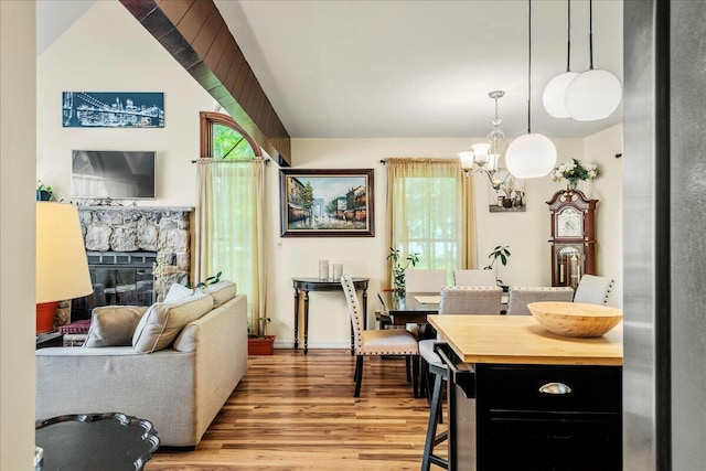 349 Mallard Ln, Bushkill, PA 18324 - living area with a chandelier, wood finished floors, and a stone fireplace