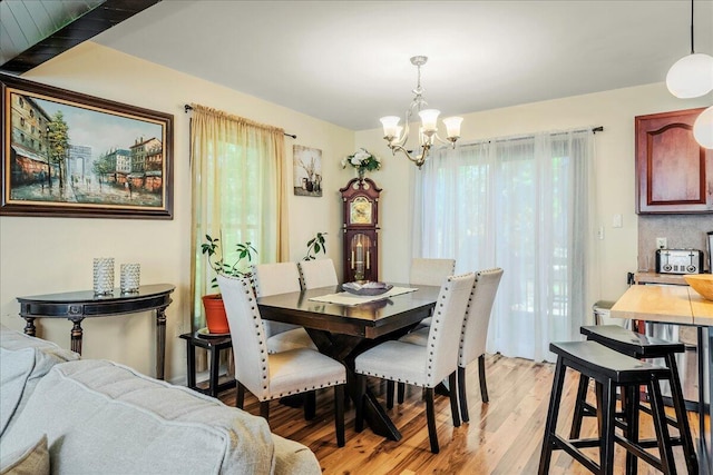 349 Mallard Ln, Bushkill, PA 18324 - dining area featuring a chandelier, light wood-style flooring, and healthy amount of natural light