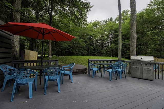 wooden terrace with grilling area and outdoor dining area