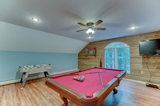 playroom featuring a ceiling fan, wood walls, lofted ceiling, and wood finished floors