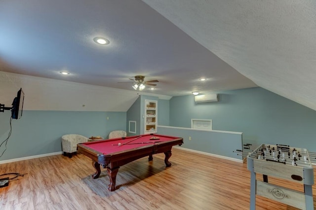 playroom featuring baseboards, a textured ceiling, and wood finished floors