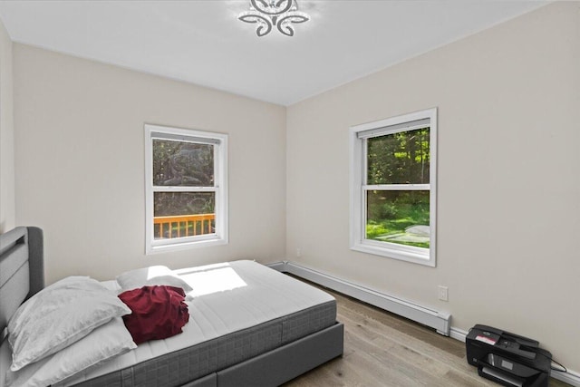 325 Chestnut Rd, East Stroudsburg, PA 18302 - bedroom featuring a baseboard heating unit and wood finished floors