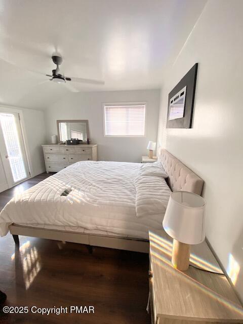 bedroom featuring lofted ceiling, ceiling fan, and wood finished floors