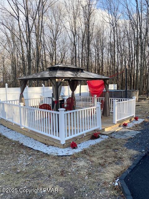 deck featuring a gazebo and fence