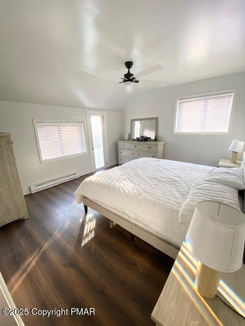 bedroom with lofted ceiling, ceiling fan, baseboard heating, and dark wood finished floors