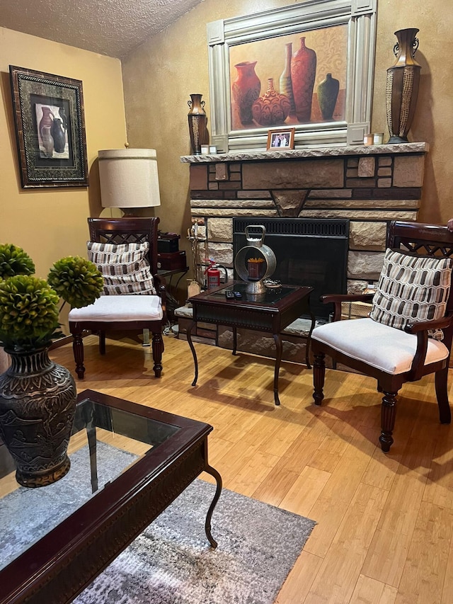 5112 Navajo Pl, Tobyhanna, PA 18466 - sitting room featuring a fireplace, wood finished floors, and a textured ceiling
