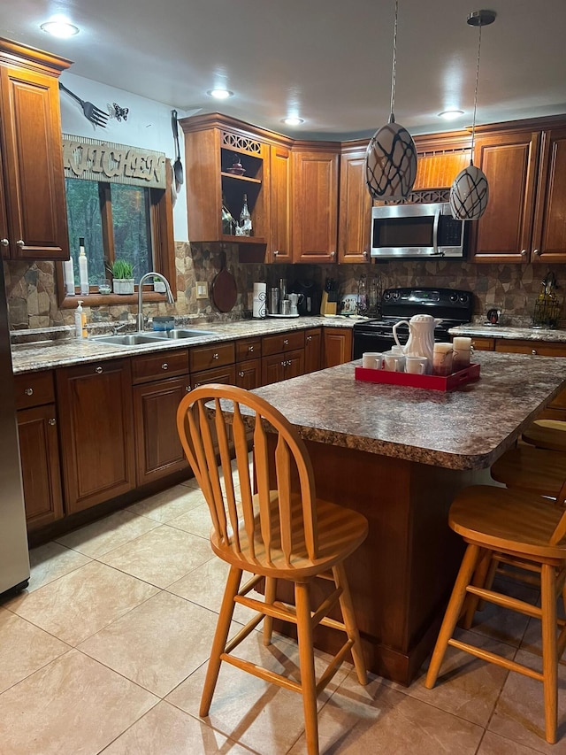 5112 Navajo Pl, Tobyhanna, PA 18466 - kitchen with black / electric stove, stainless steel microwave, decorative backsplash, a kitchen bar, and recessed lighting