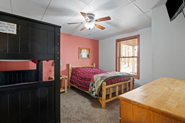 bedroom featuring a drop ceiling, ceiling fan, and carpet floors