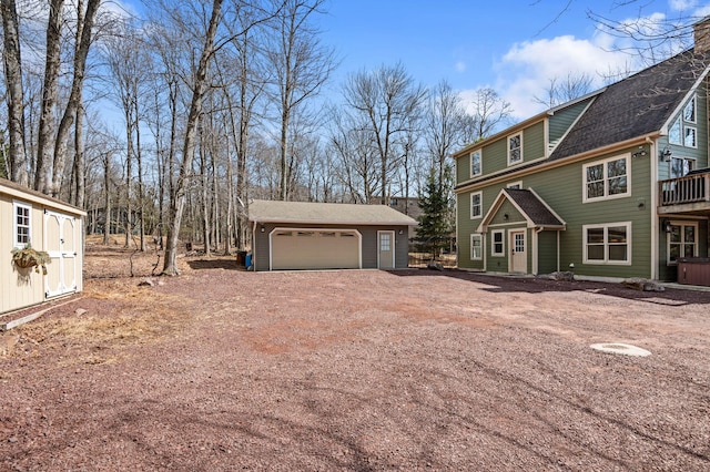 view of front of property featuring a garage and an outdoor structure