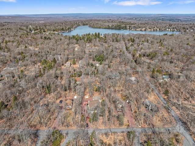 birds eye view of property featuring a wooded view and a water view