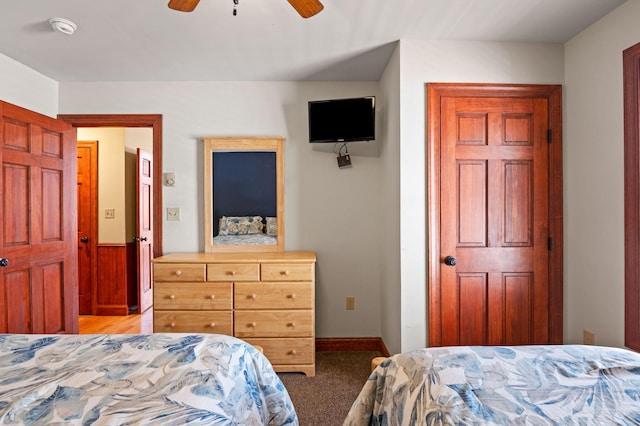 bedroom with baseboards, carpet floors, and a ceiling fan