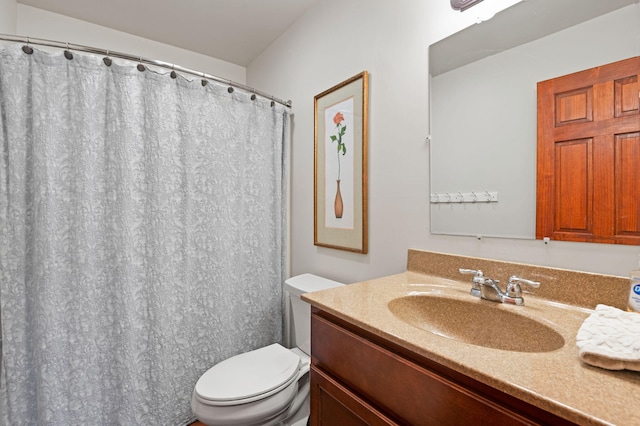 bathroom featuring toilet and vanity