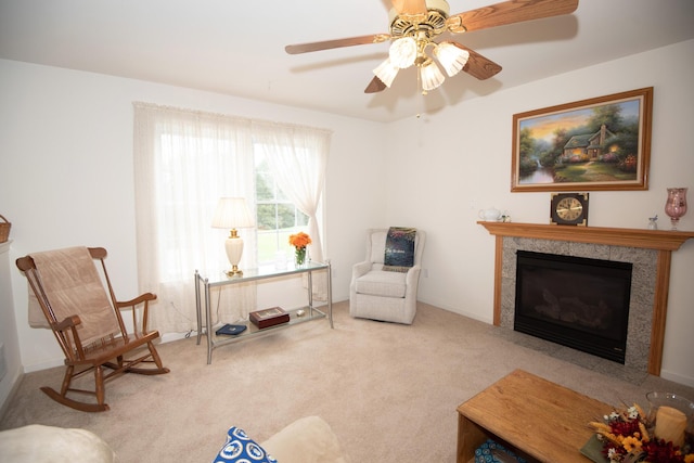 living area with ceiling fan, a fireplace, and carpet