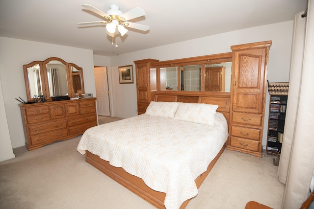 bedroom with light carpet and a ceiling fan