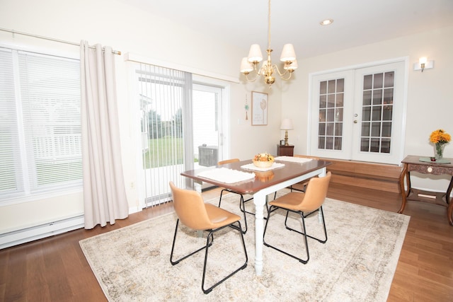 dining space featuring a notable chandelier, recessed lighting, french doors, and wood finished floors