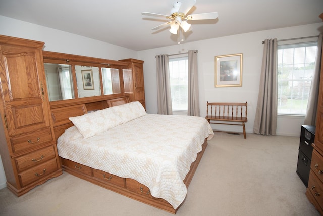 bedroom featuring ceiling fan, baseboards, and light carpet