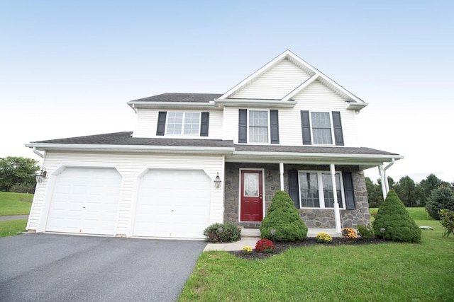 view of front of property with a front yard, a porch, stone siding, and driveway