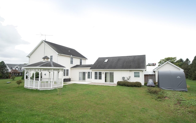 rear view of house featuring a gazebo, a patio area, and a yard