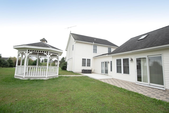 back of house with a gazebo, a patio, a lawn, and central AC