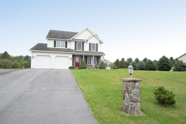 view of front facade with aphalt driveway, a porch, and a front lawn