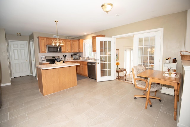 kitchen with a kitchen island, a sink, stainless steel appliances, light countertops, and pendant lighting