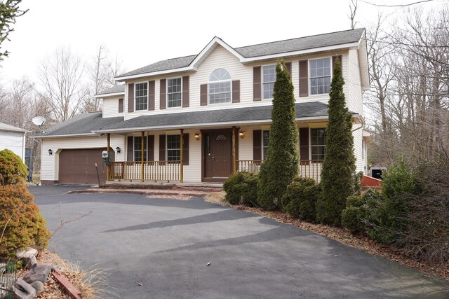 view of front facade with a garage and covered porch