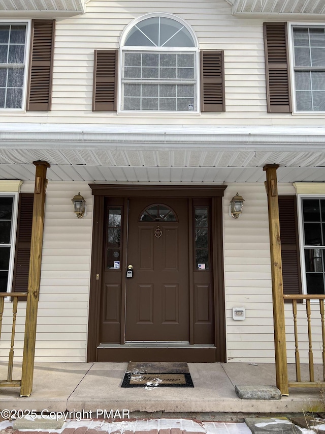 doorway to property featuring a porch