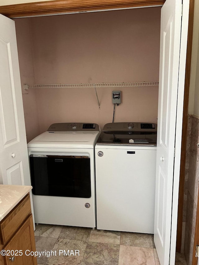 clothes washing area featuring washing machine and dryer