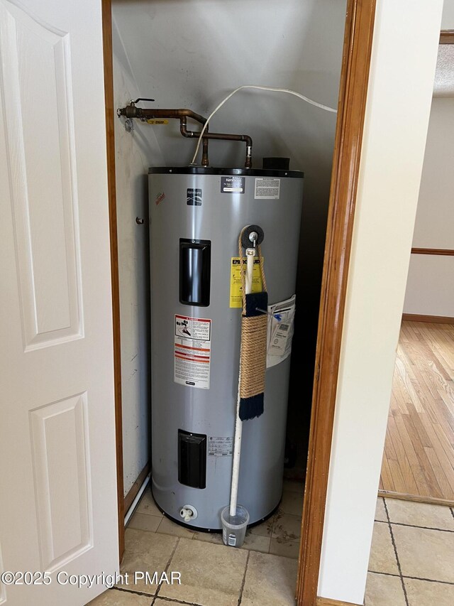 utility room featuring electric water heater